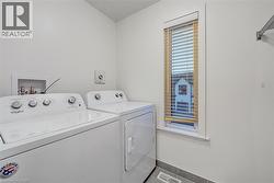 Laundry area featuring separate washer and dryer and baseboards - 
