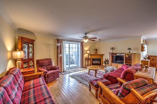 Salon - 101-1245 Rue François-Corbeil, Terrebonne (Terrebonne), QC - Indoor Photo Showing Living Room With Fireplace