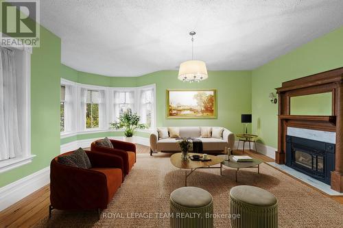 This photograph has been virtually staged. - 6722 Rideau Valley Drive S, Ottawa, ON - Indoor Photo Showing Living Room With Fireplace