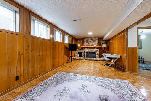 Salle familiale - 15221 Rue Théorêt, Montréal (L'Île-Bizard/Sainte-Geneviève), QC - Indoor Photo Showing Other Room With Fireplace