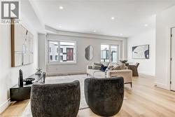 Living room with light wood finished floors and recessed lighting - 