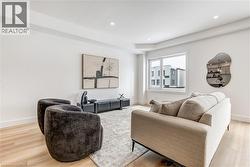 Living area featuring light wood-style flooring and recessed lighting - 