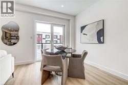 Dining space with light wood-style flooring and recessed lighting - 