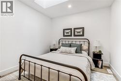 Bedroom with a skylight and recessed lighting - 