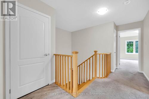 Upper level landing with laundry closet to left - 9 - 8273 Tulip Tree Drive, Niagara Falls, ON 
