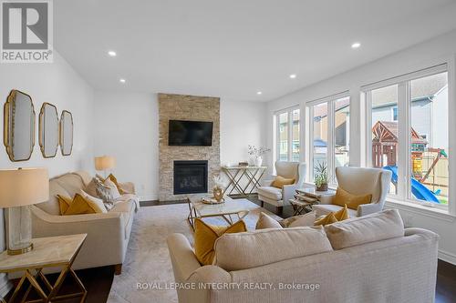great room with gas fireplace - 32 Aconitum Way, Ottawa, ON - Indoor Photo Showing Living Room With Fireplace