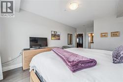 Kitchen featuring stainless steel appliances, dark brown cabinetry, recessed lighting, light stone countertops, and ceiling fan - 