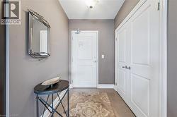 Entryway featuring light tile patterned flooring and baseboards - 
