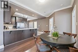 Dining area featuring ornamental molding and dark wood-type flooring - 