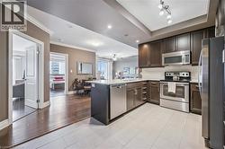 Living room with a fireplace and recessed lighting - 