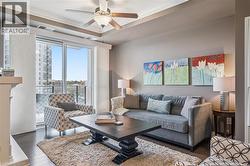 Sitting room with a glass covered fireplace and recessed lighting - 