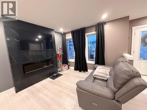 2238 Windbury Greenway Sw, Airdrie, AB - Indoor Photo Showing Living Room With Fireplace