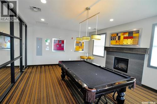 B107 415 Hunter Road, Saskatoon, SK - Indoor Photo Showing Other Room With Fireplace