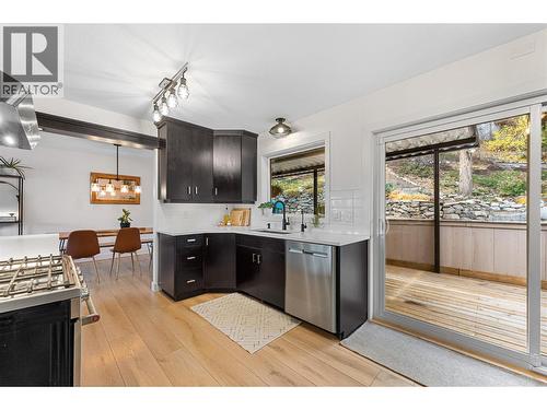 New windows and over-sized sliding door to your backyard retreat. - 3380 Mciver Road, West Kelowna, BC - Indoor Photo Showing Kitchen