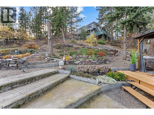 Tiered landscaping and fruit trees provide a lush backdrop in spring and summer. - 3380 Mciver Road, West Kelowna, BC - Outdoor