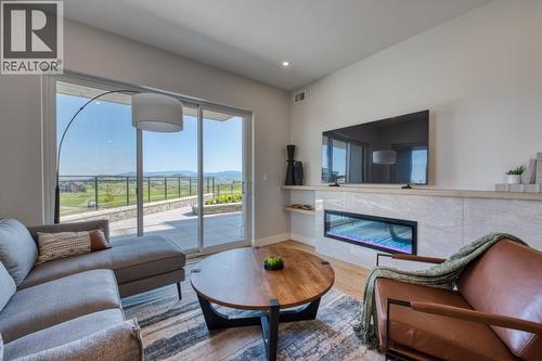 75 Predator Ridge Drive Unit# 103, Vernon, BC - Indoor Photo Showing Living Room With Fireplace