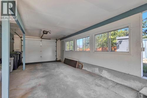 Carport with a garage door - 4693 Raymer Road, Kelowna, BC - Indoor Photo Showing Garage