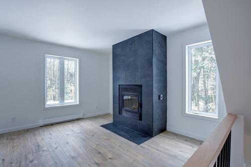 Salon - 184 Rue Lajeunesse, Saint-Colomban, QC - Indoor With Fireplace