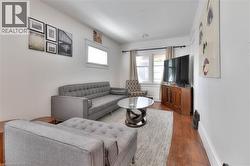 Living area with wood finished floors and baseboards - 