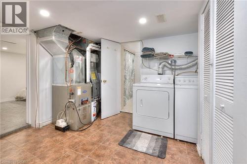 Laundry area featuring heating unit and washing machine and dryer - 50 Walnut Street, Kitchener, ON - Indoor Photo Showing Laundry Room