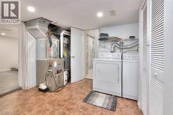 Laundry area featuring heating unit and washing machine and dryer - 