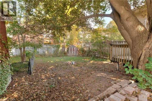 Fenced backyard with a storage shed and a wooden deck - 50 Walnut Street, Kitchener, ON - Outdoor