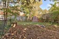 Fenced backyard featuring a storage shed - 