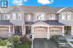 Craftsman-style home featuring stone siding and a shingled roof - 