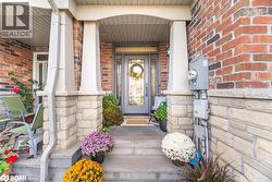 Entrance to property with covered porch and brick siding - 