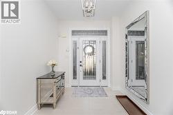 Entryway featuring a chandelier and light tile patterned floors - 