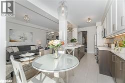 Dining room featuring light tile patterned floors and a chandelier - 