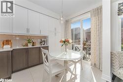 Dining space featuring light tile patterned floors - 