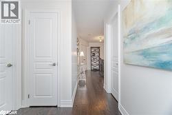 Hall with dark wood finished floors and a textured ceiling - 
