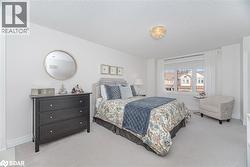 Bedroom featuring a textured ceiling and carpet flooring - 