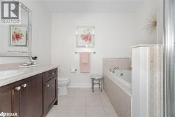 Full bath with a garden tub, light tile patterned floors, and vanity - 