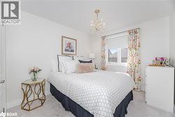 Bedroom featuring a chandelier and carpet flooring - 