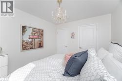 Bedroom featuring a chandelier and a textured ceiling - 