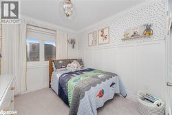 Carpeted bedroom featuring a decorative wall, a wainscoted wall, ornamental molding, wallpapered walls, and a chandelier - 