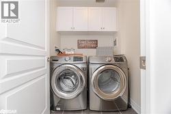 Laundry room with washing machine and dryer and cabinet space - 