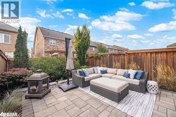 Fenced backyard featuring a patio area - 