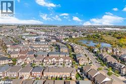 Aerial overview of property's location featuring a large body of water and nearby suburban area - 