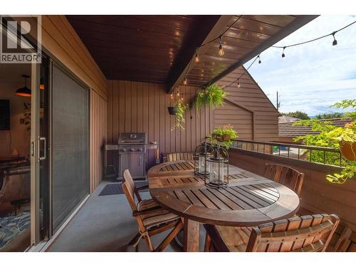 Spacious Main Patio surrounded by greenery, with a Gas BBQ Hookup. - 983 Bernard Avenue Unit# 205, Kelowna, BC - Outdoor With Deck Patio Veranda With Exterior