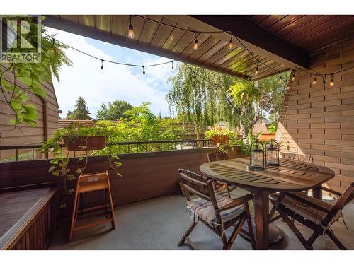 Spacious Main Patio surrounded by greenery, with a Gas BBQ Hookup. - 983 Bernard Avenue Unit# 205, Kelowna, BC - Outdoor With Deck Patio Veranda With Exterior
