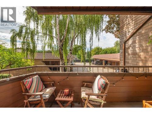 Primary Bedroom has it's own private patio surrounded by trees - 983 Bernard Avenue Unit# 205, Kelowna, BC - Outdoor With Deck Patio Veranda With Exterior