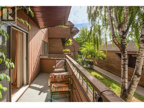 Primary Bedroom has it's own private patio surrounded by trees - 983 Bernard Avenue Unit# 205, Kelowna, BC - Outdoor With Balcony With Exterior