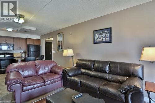 Living area featuring a textured ceiling - 776 Laurelwood Drive Unit# 705, Waterloo, ON - Indoor Photo Showing Living Room