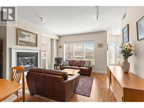 Living room with gas fireplace - 1947 Underhill Street Unit# 704, Kelowna, BC - Indoor Photo Showing Living Room With Fireplace