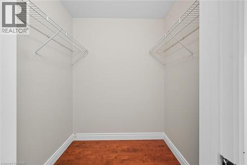 Spacious closet featuring dark wood finished floors - 8111 Forest Glen Drive Unit# 524, Niagara Falls, ON - Indoor With Storage