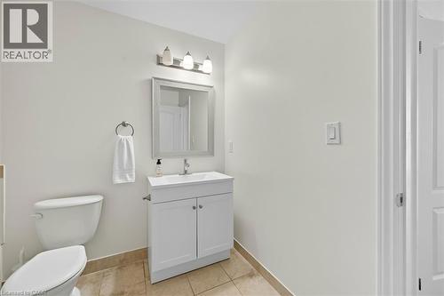Half bath with vanity and light tile patterned floors - 8111 Forest Glen Drive Unit# 524, Niagara Falls, ON - Indoor Photo Showing Bathroom