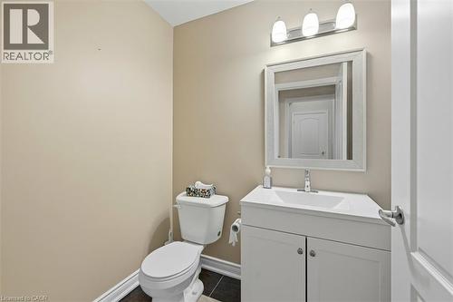 Half bath featuring vanity and dark tile patterned floors - 8111 Forest Glen Drive Unit# 524, Niagara Falls, ON - Indoor Photo Showing Bathroom